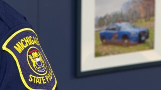 MSP Logo on trooper's shoulder and cruiser picture