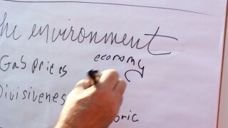 Man writes down 'economy' on the board