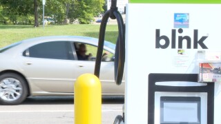 Car drives past EV charger