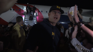 Jim Harbaugh Michigan arrive in Arizona